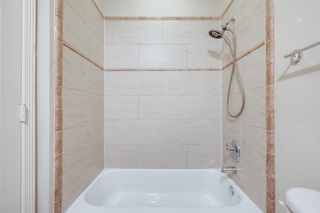 bathroom featuring toilet and shower / bathtub combination