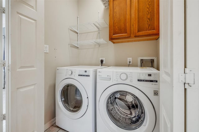 laundry room with washer and dryer and cabinet space