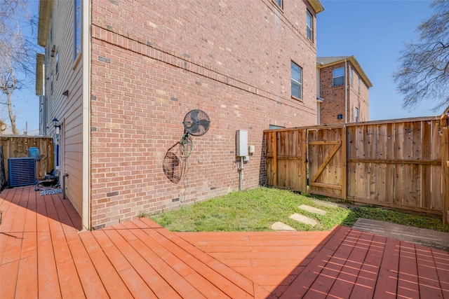 wooden deck featuring fence and a gate