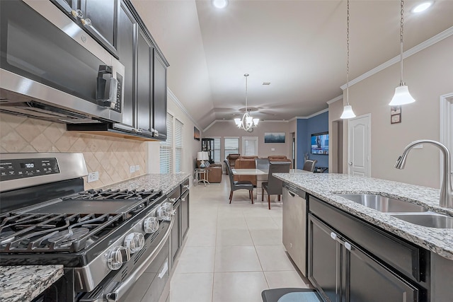 kitchen featuring a sink, ornamental molding, light tile patterned flooring, and stainless steel appliances