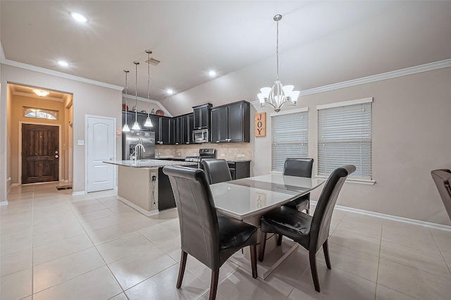 dining area with a chandelier, light tile patterned flooring, vaulted ceiling, and ornamental molding