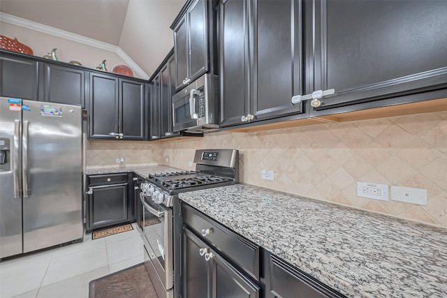 kitchen featuring light stone countertops, light tile patterned flooring, ornamental molding, decorative backsplash, and stainless steel appliances