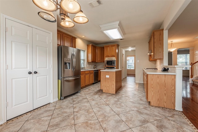 kitchen featuring visible vents, stainless steel fridge with ice dispenser, light countertops, light tile patterned floors, and dishwashing machine