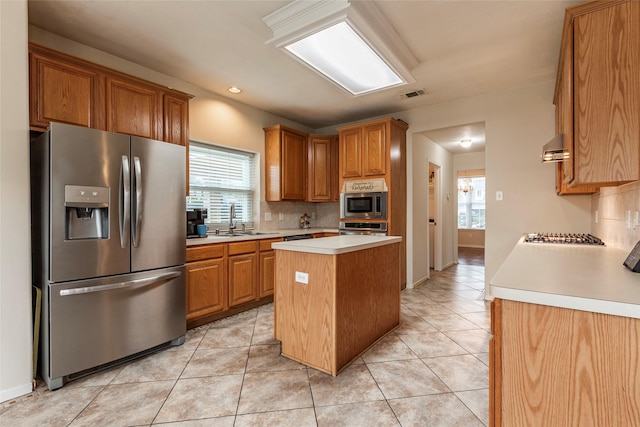 kitchen featuring light tile patterned floors, visible vents, a sink, stainless steel appliances, and light countertops