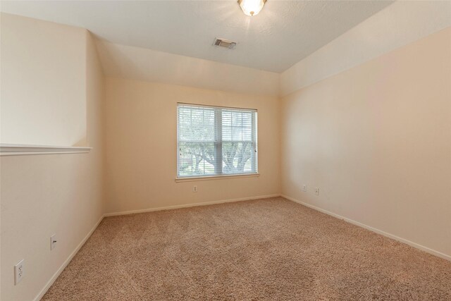 spare room with visible vents, baseboards, and carpet