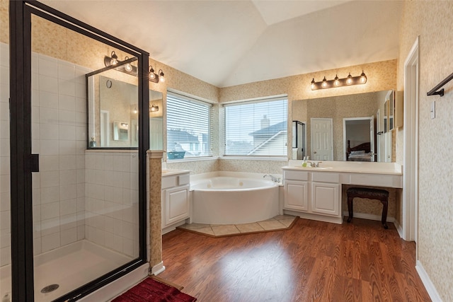 full bath featuring wallpapered walls, lofted ceiling, a stall shower, wood finished floors, and a bath