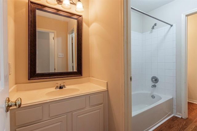 full bathroom with vanity, wood finished floors, and shower / bathtub combination