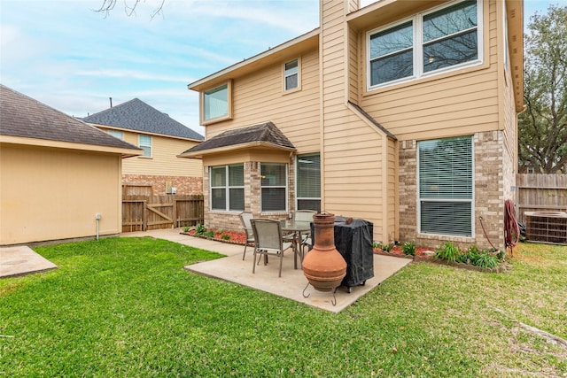 rear view of house featuring a patio, a lawn, central AC unit, and fence