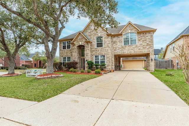 view of front of property featuring a front lawn, an attached garage, brick siding, and driveway