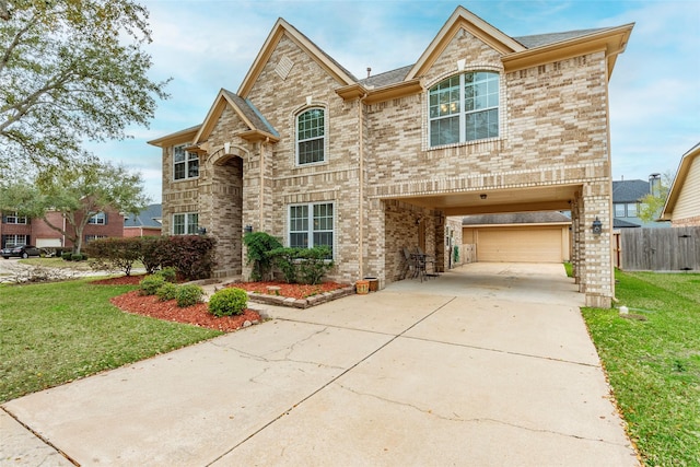 view of front of property with brick siding, driveway, and a front lawn