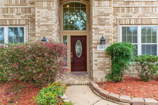 entrance to property featuring brick siding