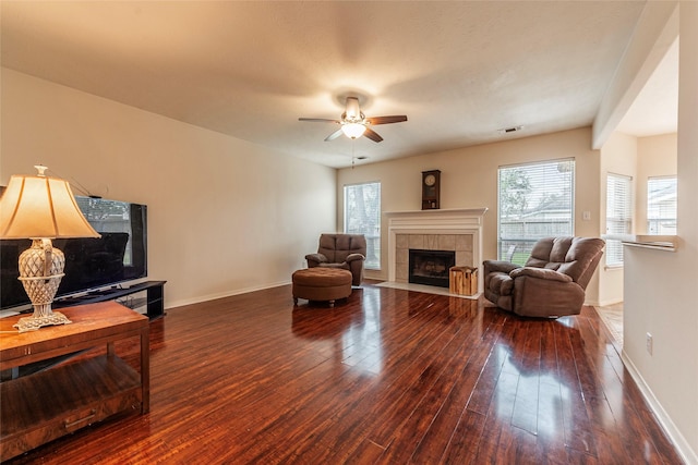 living room with a fireplace, a healthy amount of sunlight, visible vents, and wood-type flooring