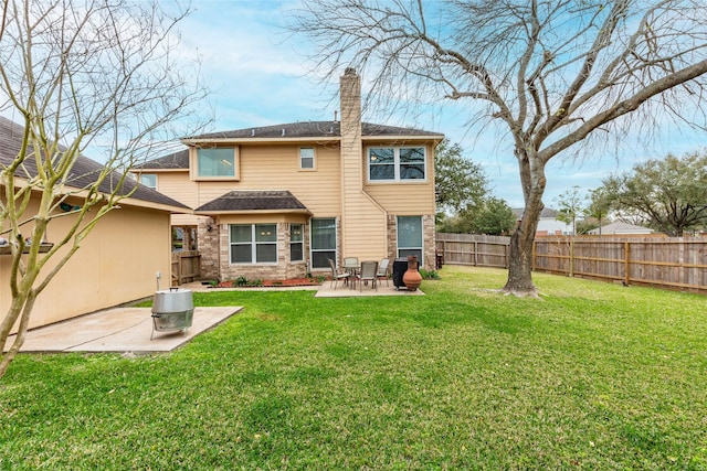 rear view of property featuring a patio area, a lawn, a chimney, and fence private yard