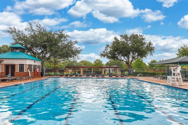 community pool with a patio, fence, and a pergola