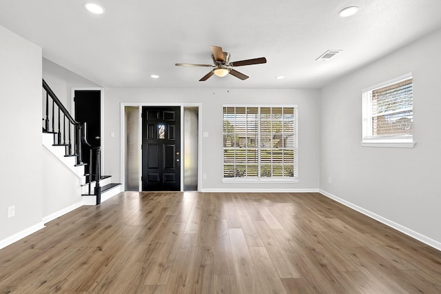 entryway featuring visible vents, wood finished floors, recessed lighting, baseboards, and stairs