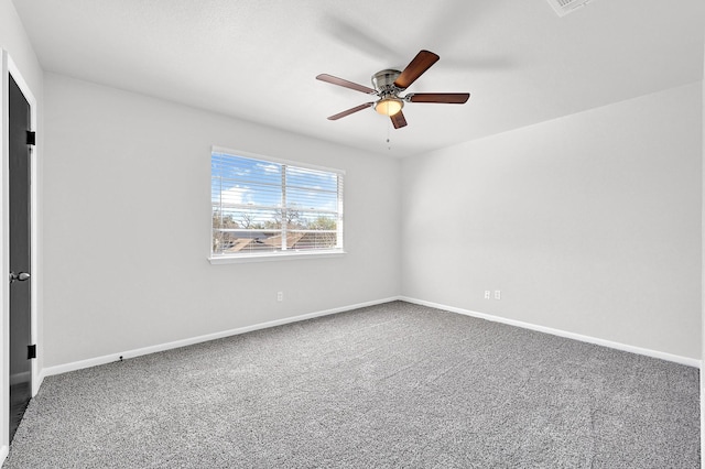 empty room featuring baseboards, carpet floors, and a ceiling fan