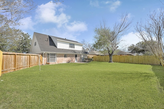 view of yard with a fenced backyard