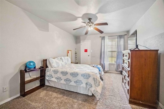 bedroom with ceiling fan, baseboards, and carpet floors