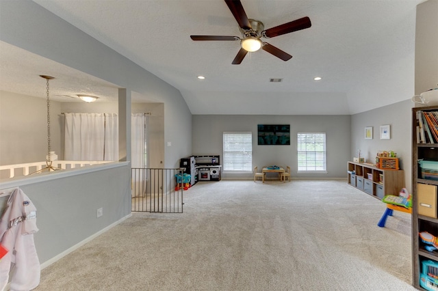 recreation room featuring visible vents, baseboards, lofted ceiling, carpet floors, and recessed lighting