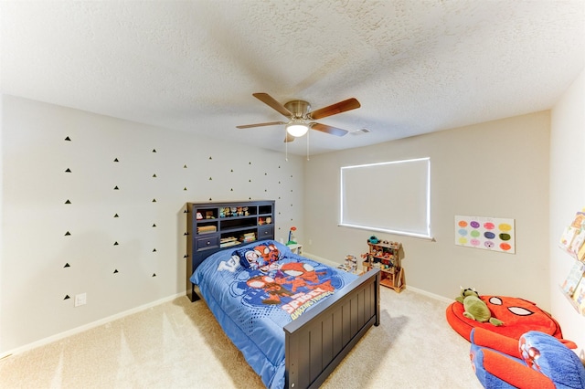 bedroom featuring baseboards, a ceiling fan, visible vents, and light carpet