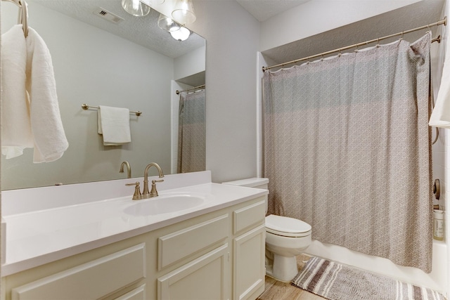 full bath with vanity, visible vents, a textured ceiling, toilet, and shower / tub combo with curtain