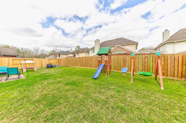 view of playground with a yard and a fenced backyard