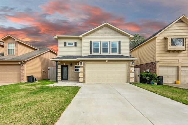 view of front of property with roof with shingles, driveway, brick siding, a garage, and a yard