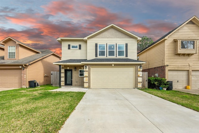 view of front of property with an attached garage, brick siding, a yard, and driveway