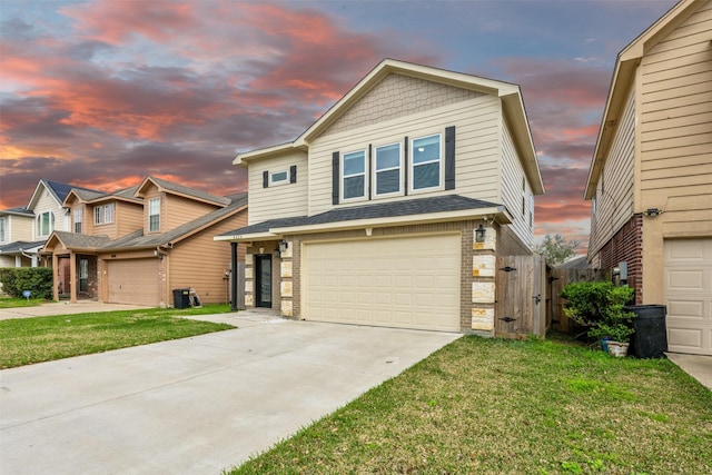 view of front facade featuring brick siding, an attached garage, concrete driveway, and a front yard