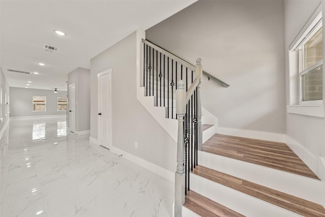 stairs with recessed lighting, visible vents, marble finish floor, and baseboards