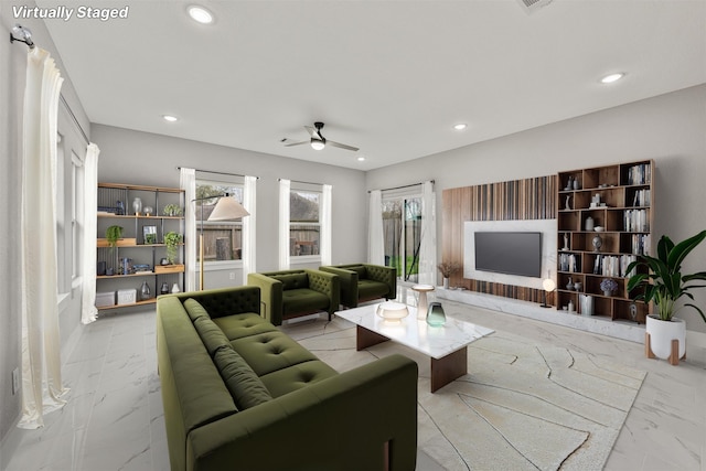 living room with recessed lighting, marble finish floor, and ceiling fan