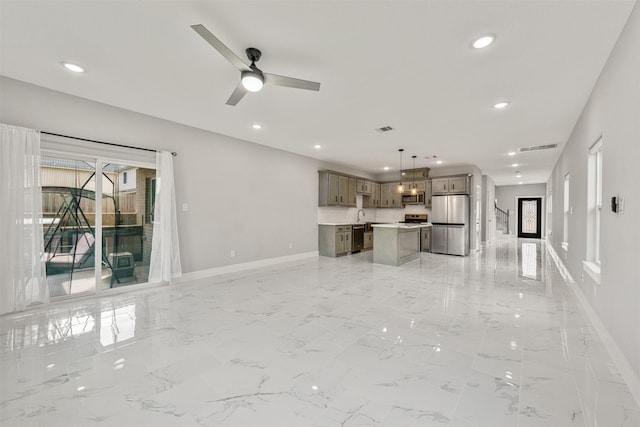 unfurnished living room featuring visible vents, recessed lighting, marble finish floor, and baseboards