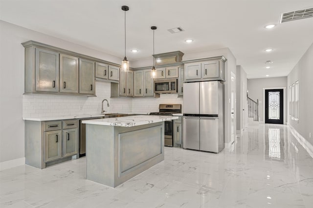 kitchen with a sink, visible vents, marble finish floor, and stainless steel appliances