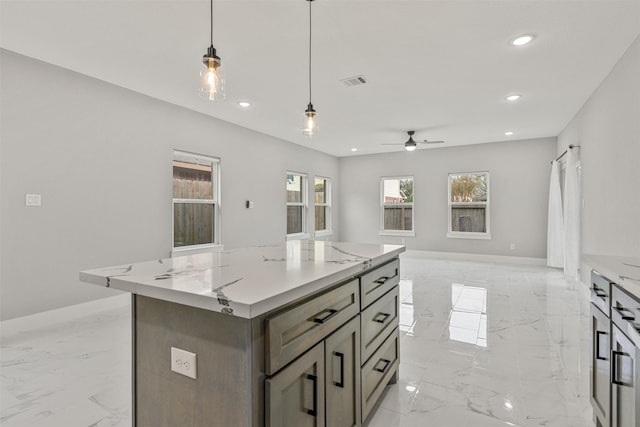 kitchen with pendant lighting, a ceiling fan, marble finish floor, and recessed lighting