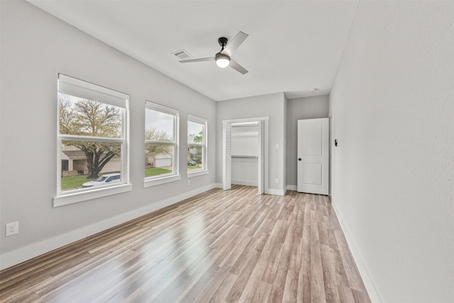 unfurnished living room with visible vents, ceiling fan, baseboards, and light wood-style floors