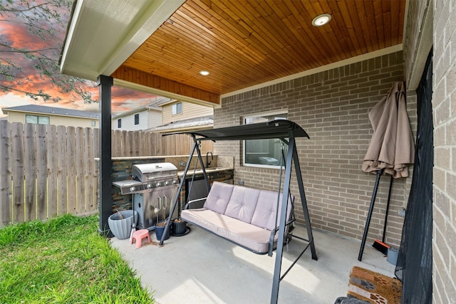 view of patio / terrace featuring a grill and fence