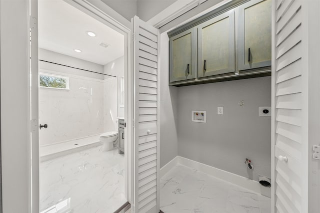 washroom with marble finish floor, hookup for a gas dryer, cabinet space, baseboards, and hookup for an electric dryer