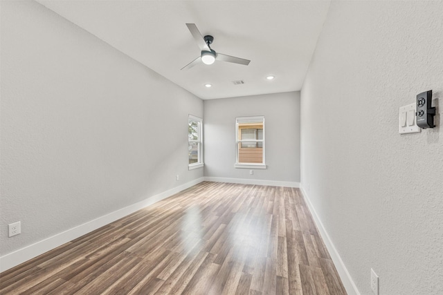 unfurnished room with wood finished floors, visible vents, baseboards, recessed lighting, and ceiling fan