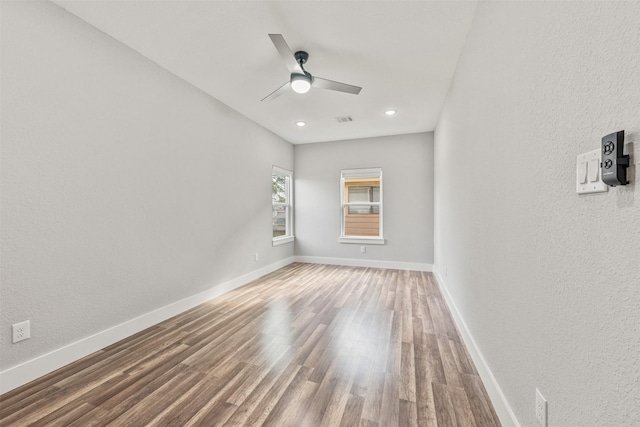 unfurnished room featuring baseboards, recessed lighting, visible vents, ceiling fan, and wood finished floors