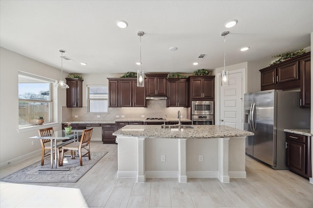 kitchen featuring a sink, visible vents, dark brown cabinetry, and appliances with stainless steel finishes