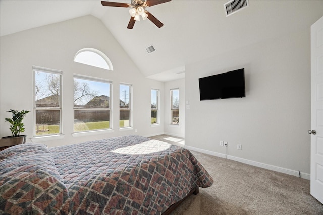 carpeted bedroom with a ceiling fan, baseboards, visible vents, and high vaulted ceiling