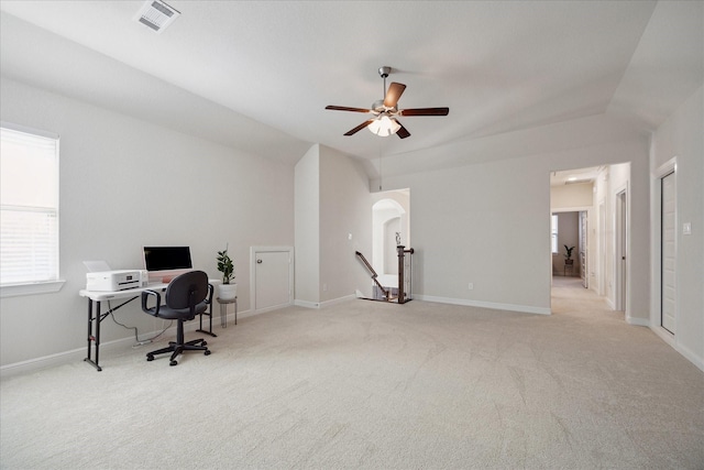 home office featuring arched walkways, visible vents, light carpet, and baseboards