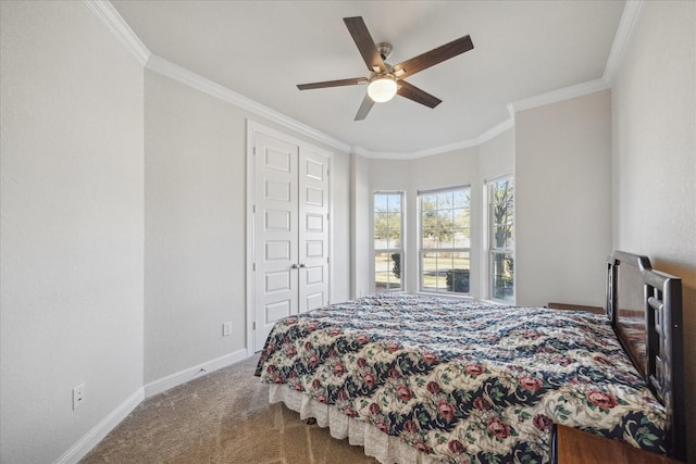 carpeted bedroom with ceiling fan, baseboards, and ornamental molding