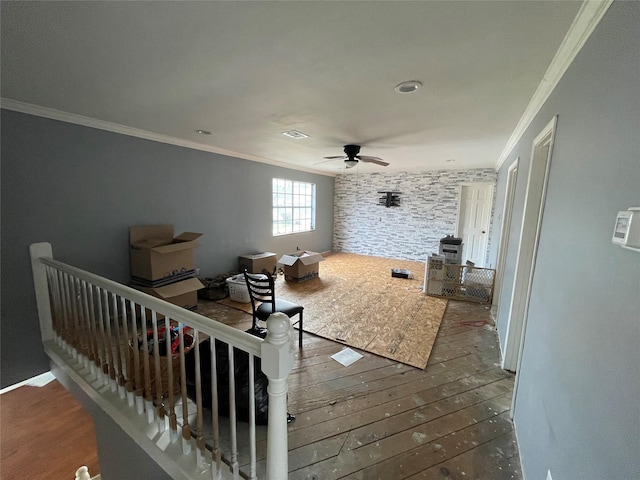 interior space with visible vents, crown molding, a ceiling fan, and hardwood / wood-style flooring