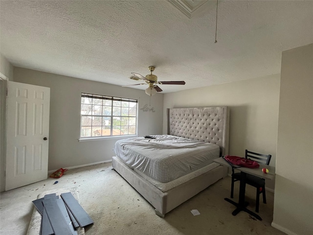 bedroom with attic access, a textured ceiling, baseboards, and a ceiling fan