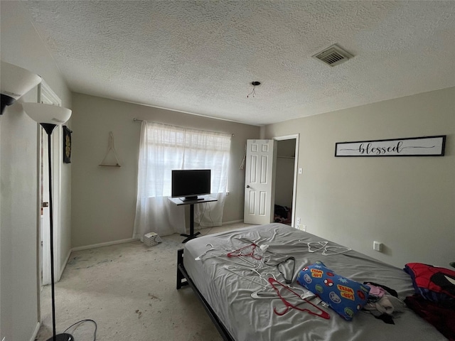 bedroom featuring visible vents and a textured ceiling