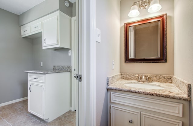 bathroom with tile patterned floors, vanity, and baseboards