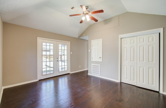 unfurnished bedroom featuring french doors, visible vents, wood finished floors, and vaulted ceiling