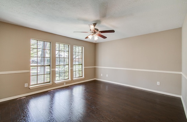 unfurnished room with dark wood-style floors, a textured ceiling, a ceiling fan, and baseboards