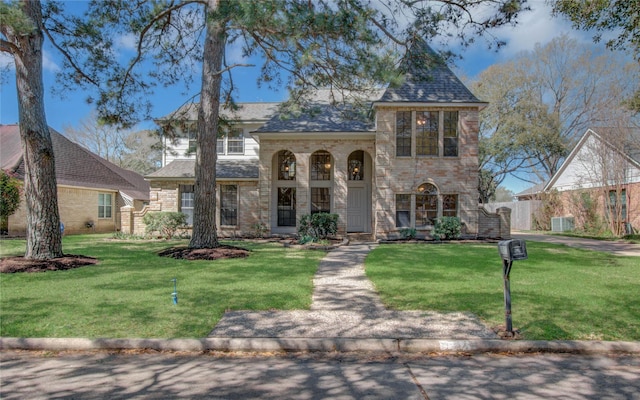 view of front facade featuring a front lawn, brick siding, and a shingled roof